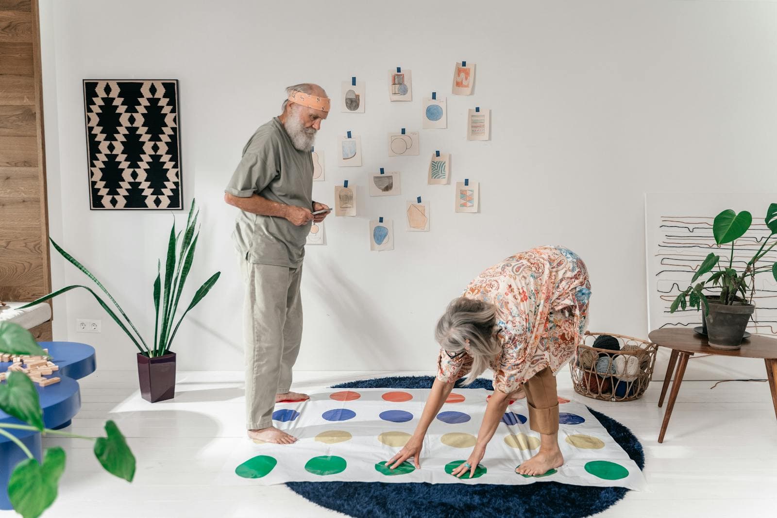 A senior couple plays a board game together — companion-led activities that combat isolation.